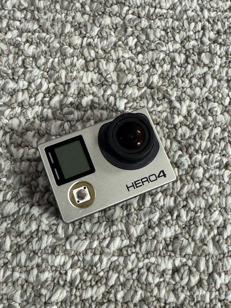 GoPro HERO4 action camera, silver body with black lens and LCD screen