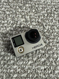 GoPro HERO4 action camera, silver body with black lens and LCD screen