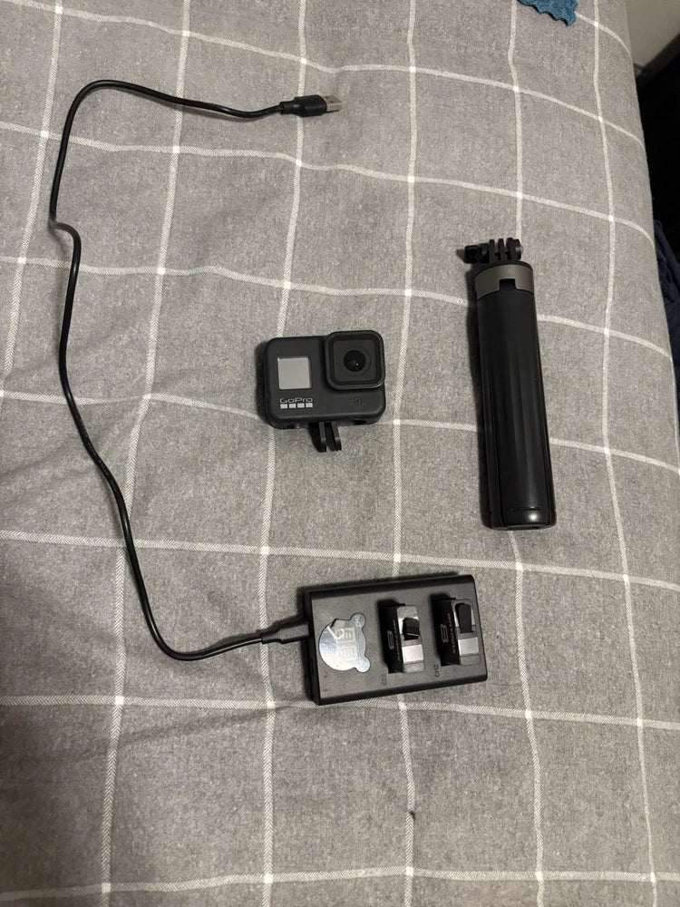 GoPro HERO8 action camera kit with waterproof housing and black mounts, grip, and case