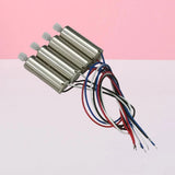 Set of four mini motors with shafts and colored wire leads