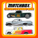Matchbox custom lowering base set on blister card, showing two model trucks and logo