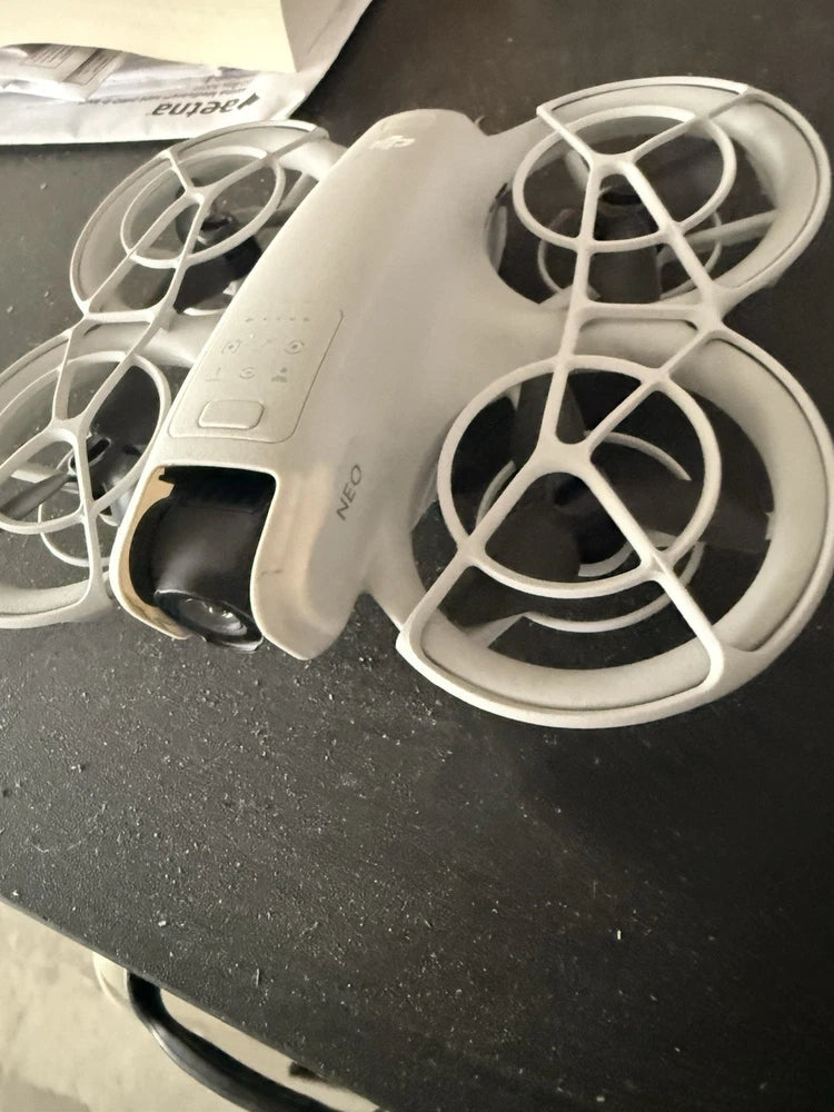 DJI Neo drone with four propellers, white body and landing gear