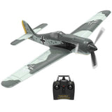 Gray RC warbird model airplane with propeller and remote transmitter