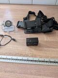 Black action camera with chest mount straps and clear waterproof housing