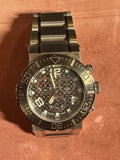 Men's chronograph wristwatch with metal bracelet, dark dial, and bezel markers