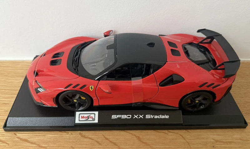 Maisto die-cast red Ferrari SF90 XX Stradale model car on black display base