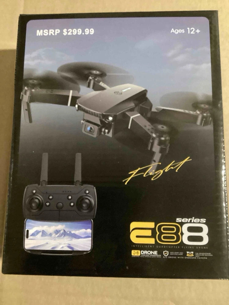 Gray foldable dual-camera drone with LED light and controller, retail package