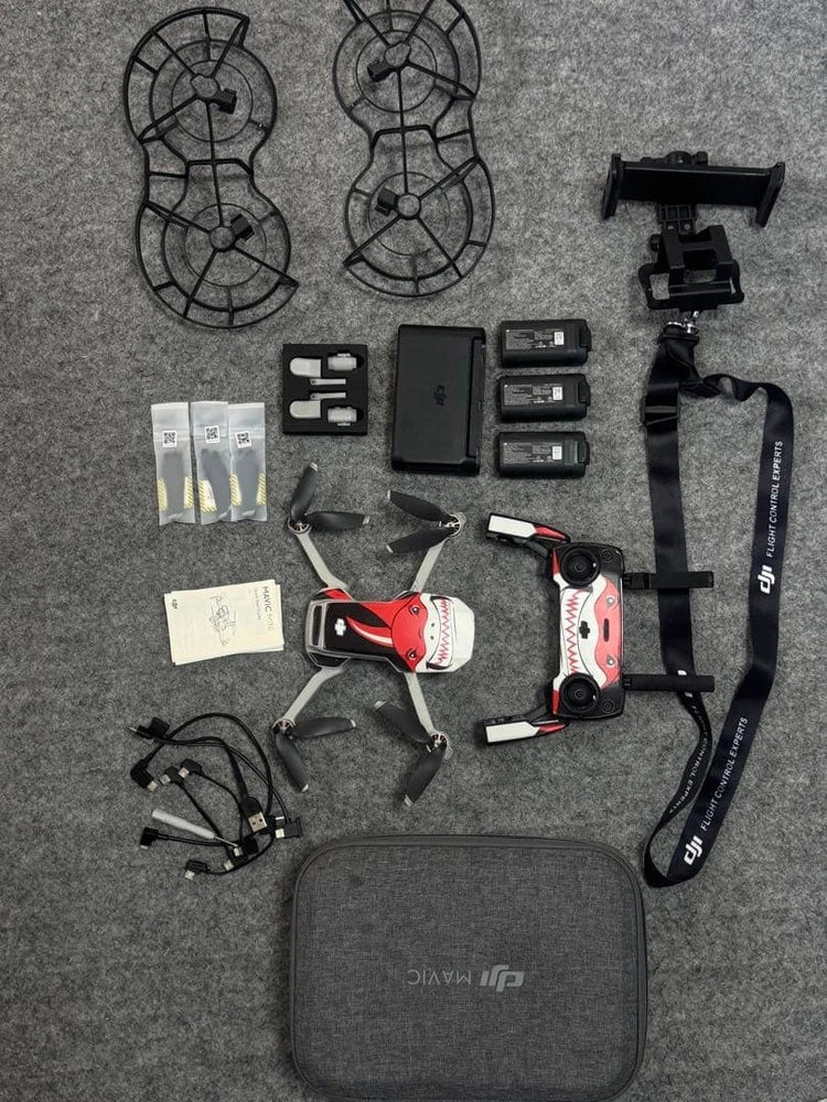Drone accessories kit with quadcopter, controller, batteries, prop guards, and carrying case