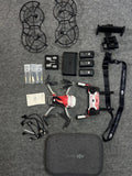 Drone accessories kit with quadcopter, controller, batteries, prop guards, and carrying case