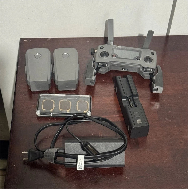 Drone accessories set with two battery packs, charger, cables, and control device