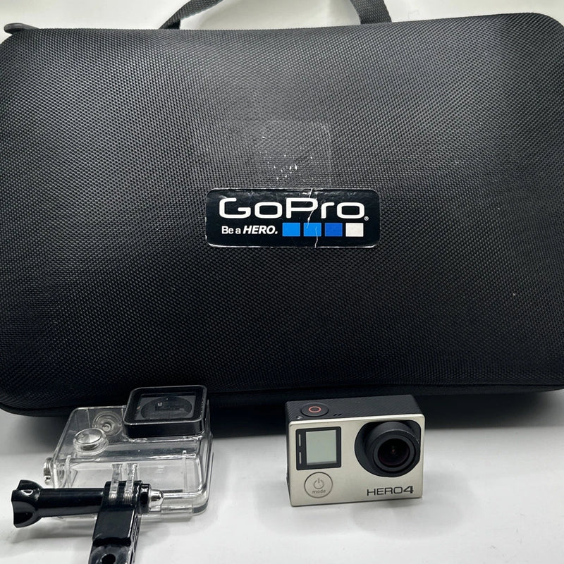 GoPro HERO4 action camera with clear housing, silver body, and black carrying case