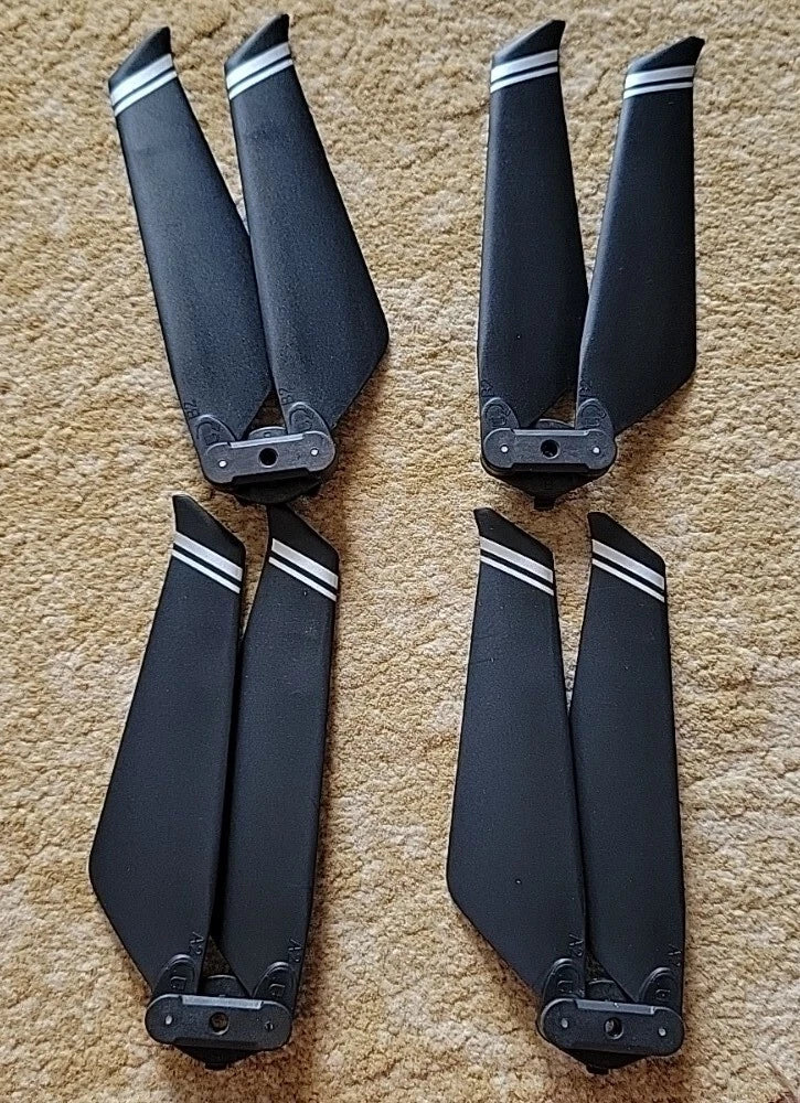 Set of four dark drone replacement propeller blades with mounting hubs