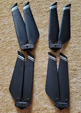 Set of four dark drone replacement propeller blades with mounting hubs