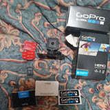 GoPro HERO 4 Session action camera with accessories and box packaging