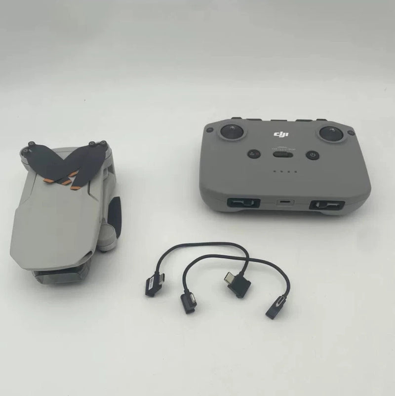 DJI Mini 2 RC controller with gray body and attached cable adapters