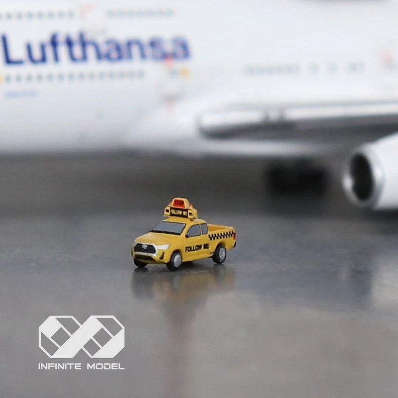 Painted yellow airport follow-me car model with taxi-style markings