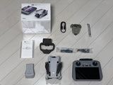 DJI Mini 4 Pro drone with DJI RC-2 controller and charging accessories laid out