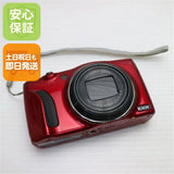 Red used digital camera with lens and wrist strap, front view