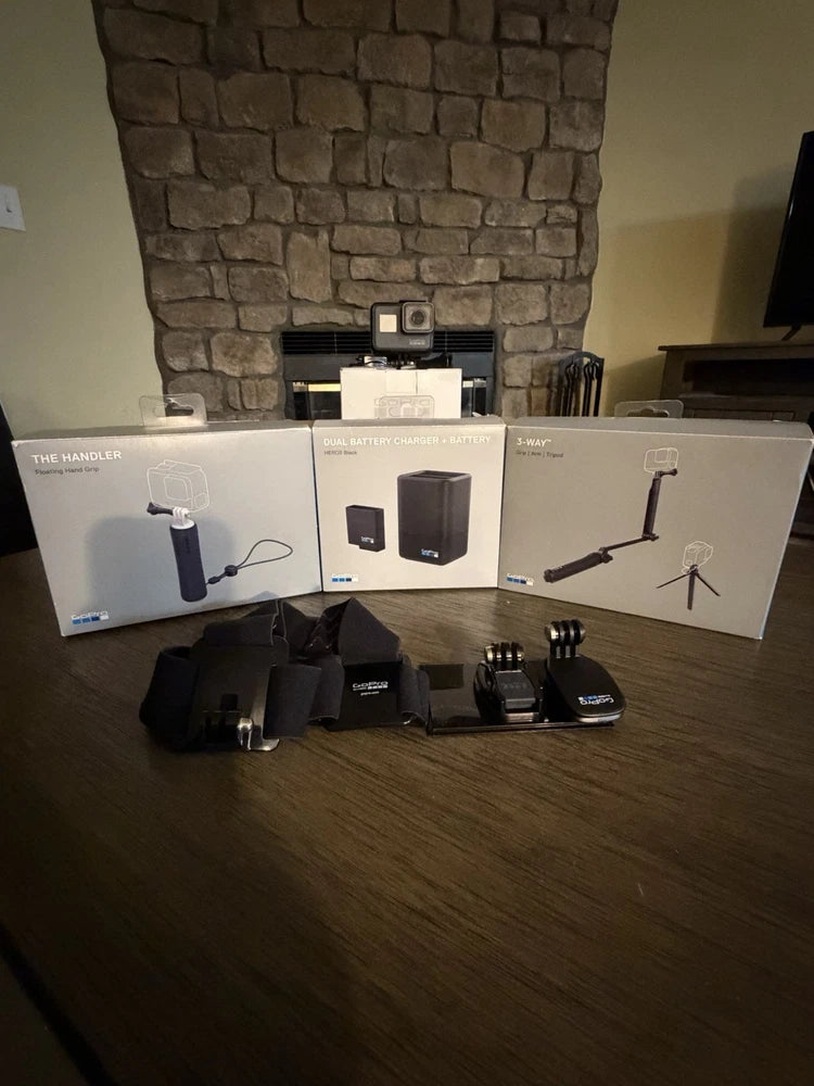 Black GoPro HERO8 action camera kit with mounts, tripod, charger, and accessory grips