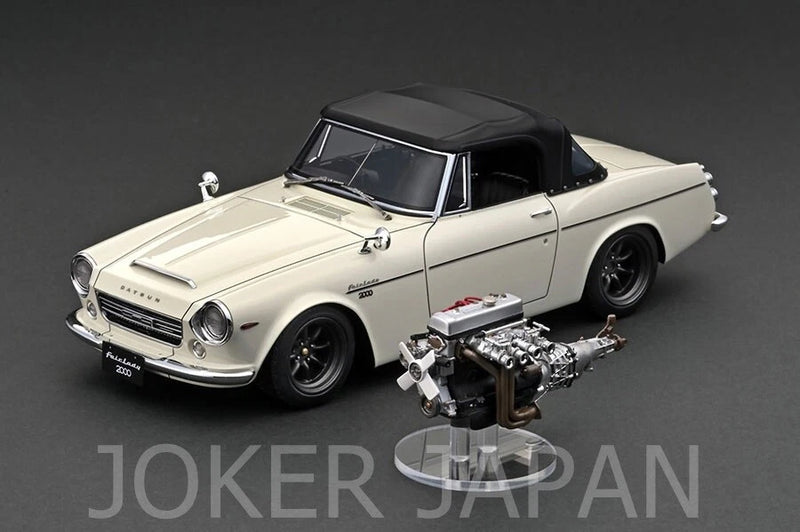 White 1/18 scale classic coupe model with black roof and exposed engine detail