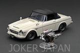 White 1/18 scale classic coupe model with black roof and exposed engine detail