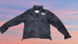 Black zip-up heated jacket with stand collar, front pockets, and adjustable cuffs.