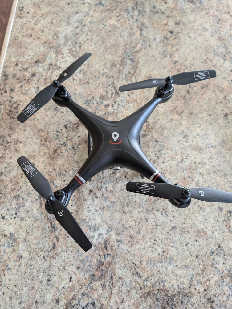 Black quadcopter drone with four propellers