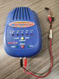 Blue battery fast charger with LED buttons and connected red/black wires