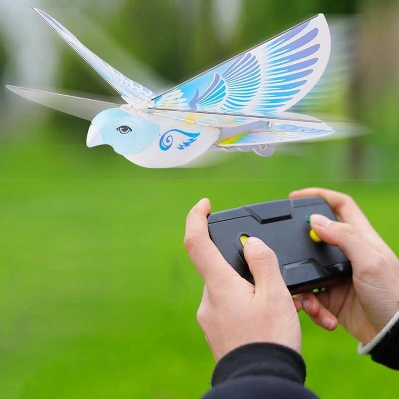 White bird-shaped mini RC drone with blue wings and controller in hands