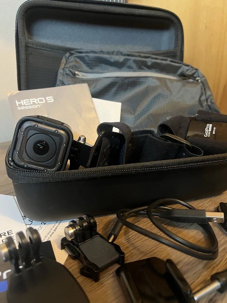 GoPro action camera with accessories in a black zip case, including mounts and cables
