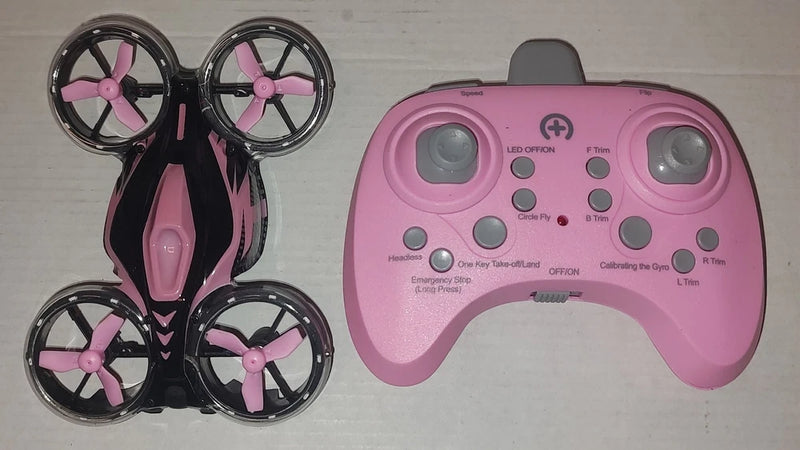 Pink beginner drone with remote controller, showing thumb sticks and button layout