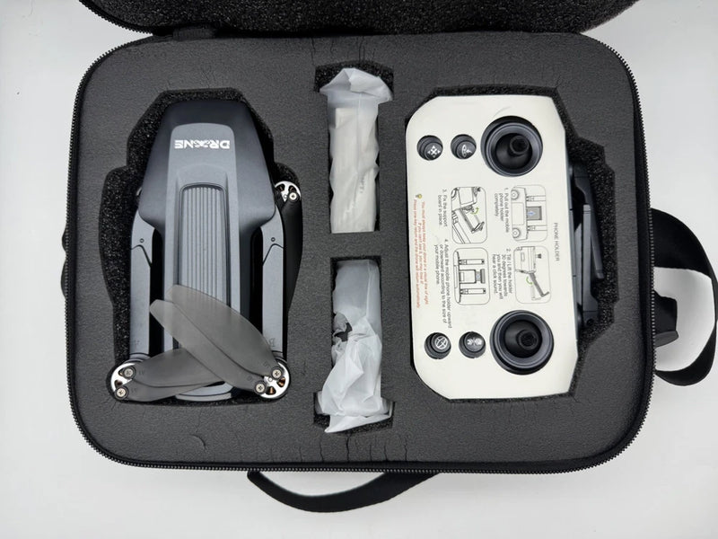 Foldable quadcopter drone and white remote in a zippered carrying case, dark grey