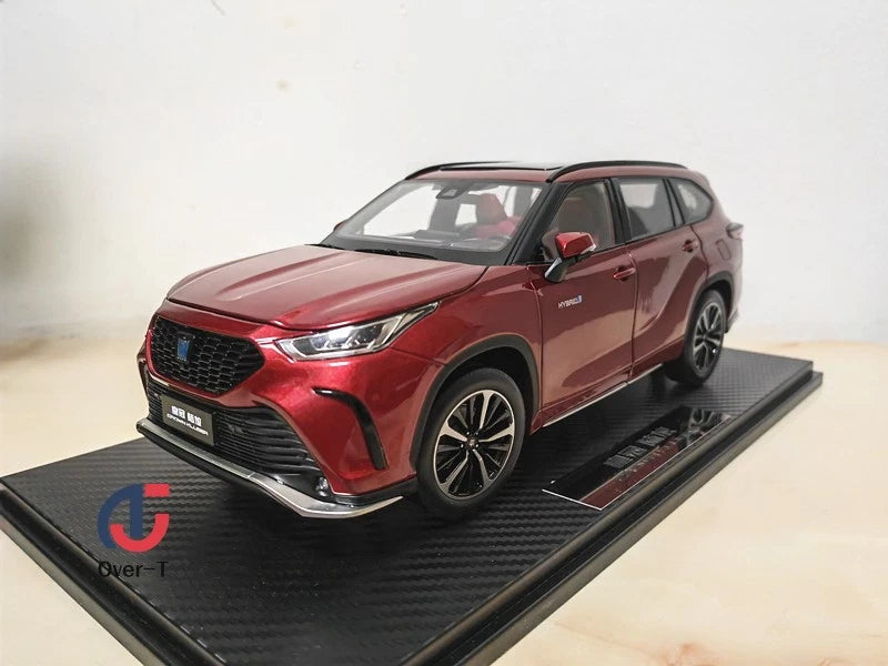 Red die-cast car model with Crown Kluger badge on black display base