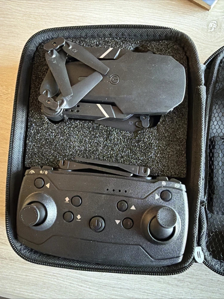 Foldable drone with remote controller, in carrying case with molded foam lining