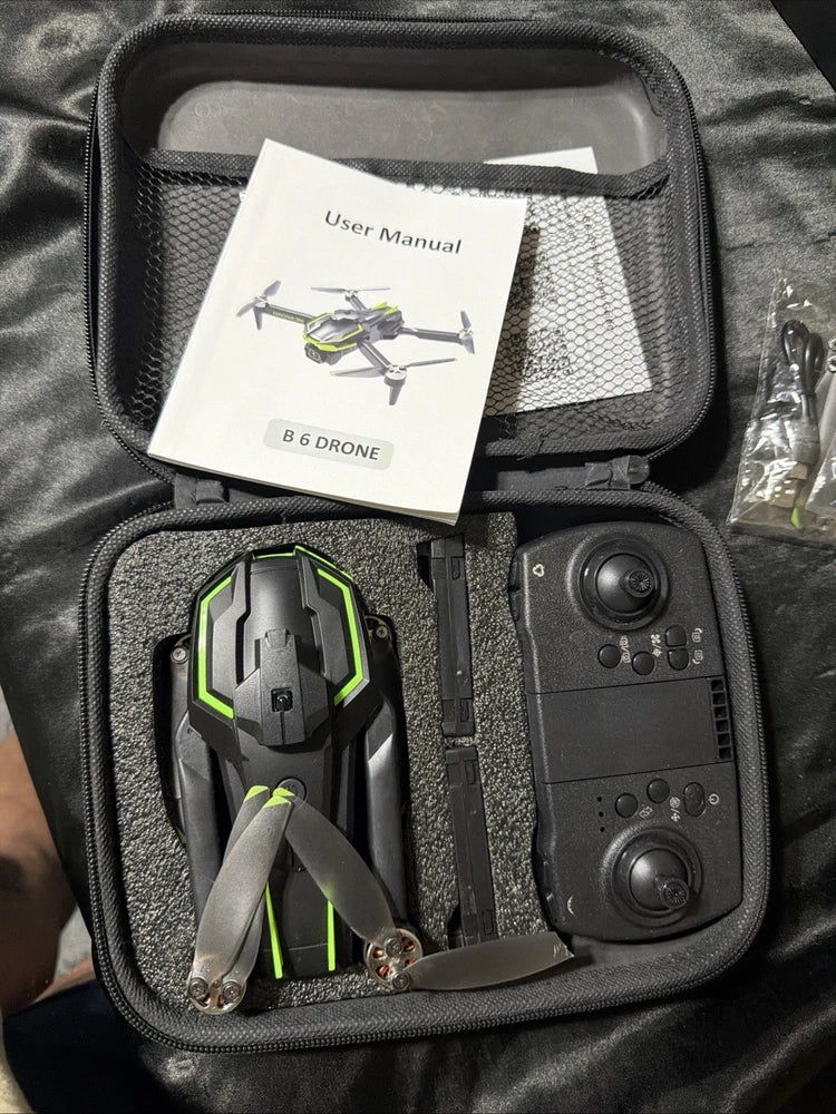 Drone with remote controller and user manual in hard case, green accents