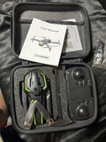 Drone with remote controller and user manual in hard case, green accents