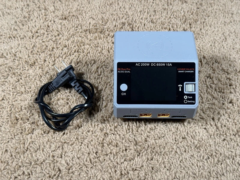 RC battery charger with LCD screen and input/output ports, with power cable