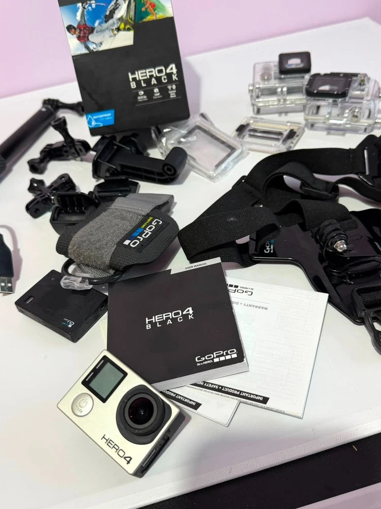 GoPro Hero4 Black action camera bundle with mounts, cases, batteries, and accessories
