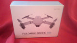 Foldable drone E88 on retail box, with drone illustration and Age 14+ label