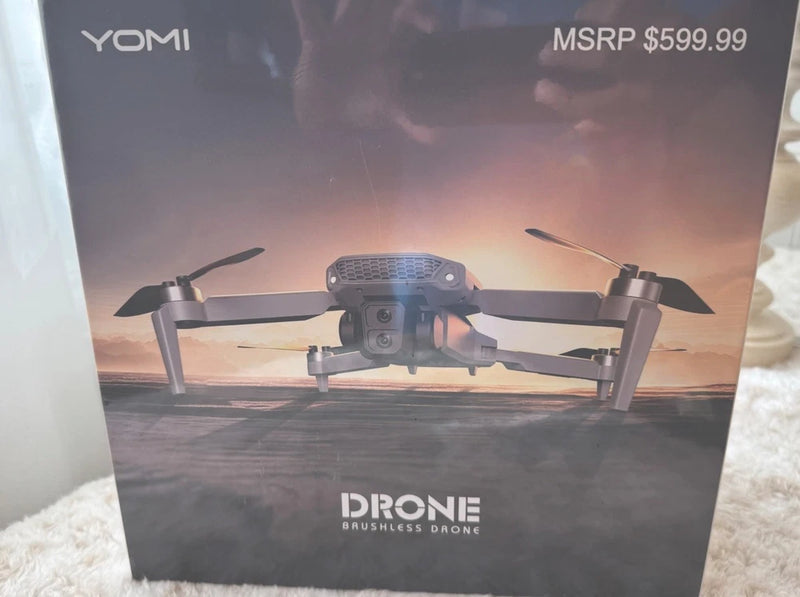 YOMI brushless quadcopter drone with camera and four propellers on retail box