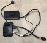 Wheelchair battery charger and controller with connected cables, blue and black case