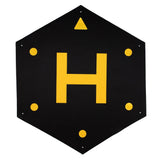Hexagonal drone landing pod with reflective yellow symbols and corner holes