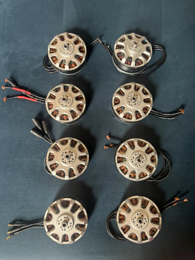 Set of eight used brushless motors with exposed wiring and circular housings