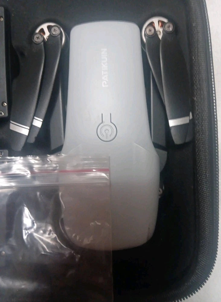 Foldable camera drone in hard case, white body with folded prop arms