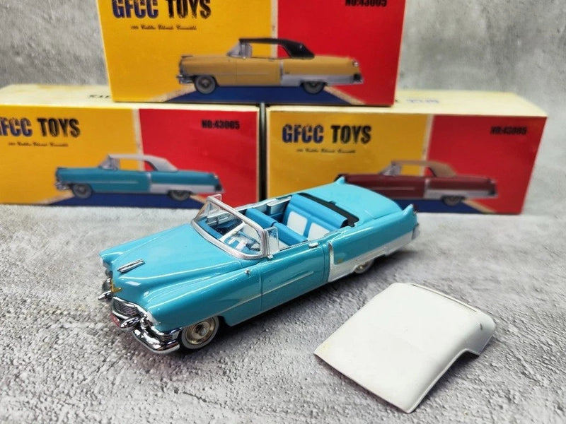 Blue convertible car model with open white roof panel, die-cast scale car