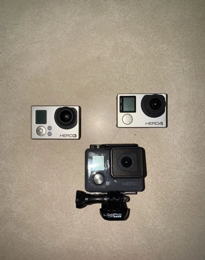 GoPro HERO cameras and accessories, three silver action cameras with mounts