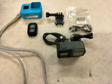 GoPro action camera kit with protective housing, mounts, and blue case