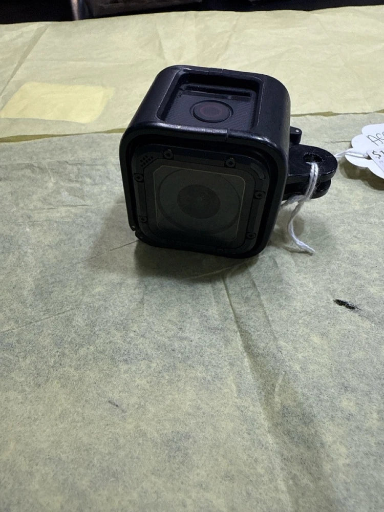 Black GoPro HERO Session action camera with front lens cover and mounting bracket