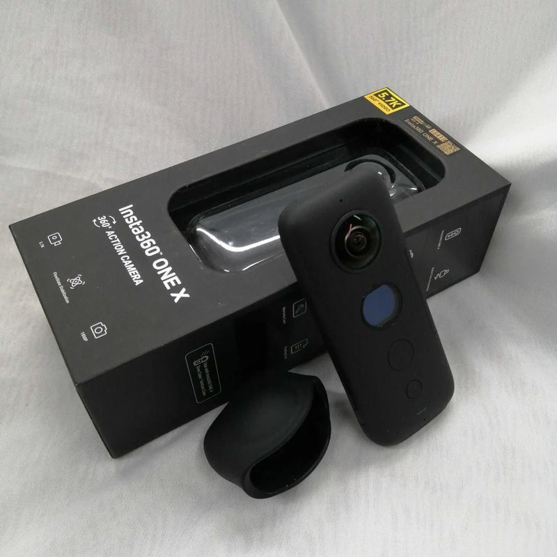 INSTA360 One X used black action camera with lens and side controls, with mounting grip