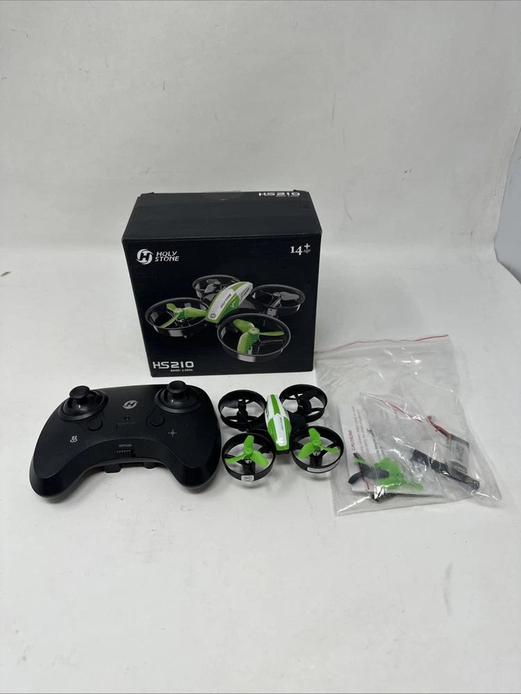 Drone quadcopter parts kit with black remote controller and small green propellers